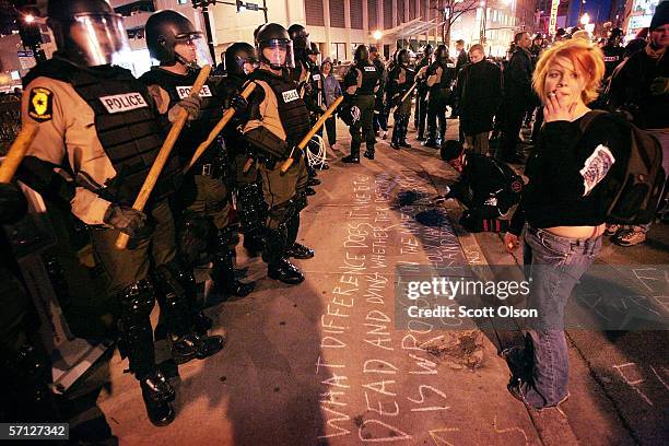 Police and protestors rally before the start of an anti-war demonstration marking the third anniversary of the invasion of Iraq March 18, 2006 in...