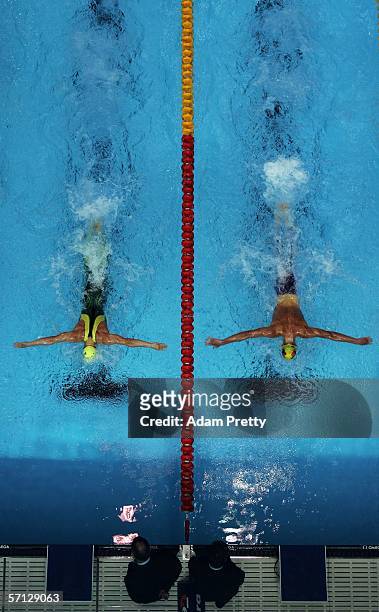 Adam Pine of Australia and Ryan Pini of Paupua New Guinea head for the wall during the men's 100m butterfly semi-final during the swimming at the...