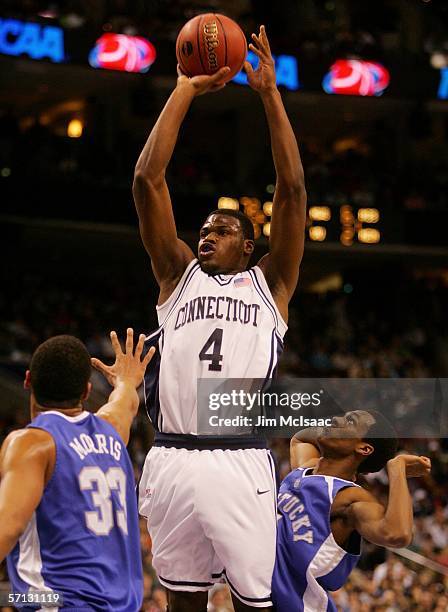 Jeff Adrien of the Connecticut Huskies puts up a jumpshot over Randolph Morris and Rajon Rondo both of the Kentucky Wildcats during the Second Round...