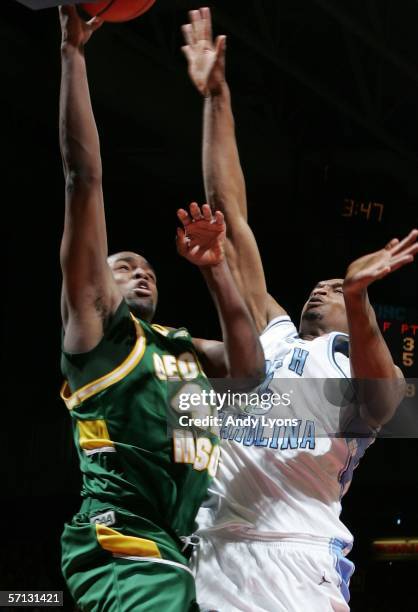 Folarin Campbell of the George Mason Patriots shoots over Reyshawn Terry of the North Carolina Tar Heels during the Second Round of the 2006 NCAA...