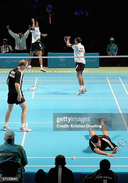 Sanave Thomas and Rupesh Kumar of India celebrate their bronze medal win in their mixed team badminton match as Craig Cooper of New Zealand falls to...