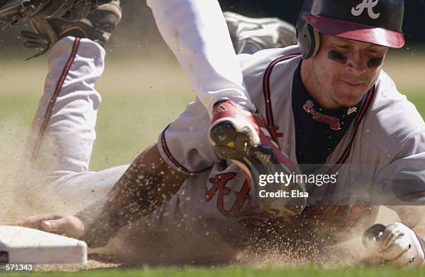 Darren Bragg of the Atlanta Braves is caught stealing third and is out in the ninth inning during the game at Busch Stadium in St. Louis, Missouri on...