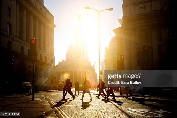 walking to work through the city at sunrise - schemer stockfoto's en -beelden