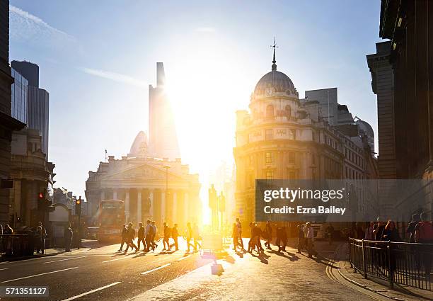 walking to work through the city at sunrise. - morning sunlight stock pictures, royalty-free photos & images