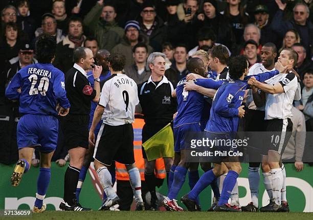 Ricardo Carvalho of Chelsea pushes Heidar Helguson of Fulham as referee Mike Dean blows his whistle during the Barclays Premiership match between...