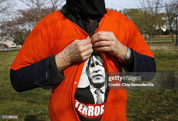 Anti-war protester David Barrows of the DC Anti-War Network dresses in an orange jumpsuit to look like detainees at U.S. Military prisons at Abu...