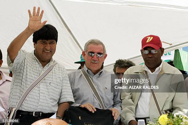 Bolivia's President Evo Morales waves to supporters next to Cuban Minister of Education Luis Ignacio Gomez and Venezuelan Minister of Education,...