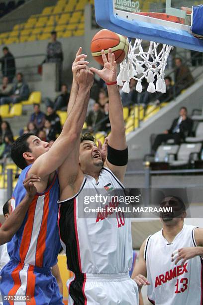 Zaid al-Kass from Jordan?s Riyadhi Aramex fights for the ball with Jihad al-Murr from Lebanon?s Blue Stars during their West Asian Super League...