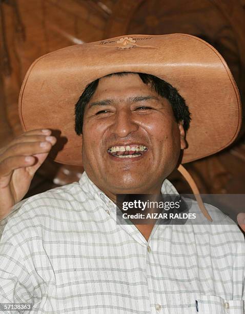 Bolivia's President Evo Morales smiles while tries a typical Santa Cruz department hat, during the inauguration of the literacy campaign, 20 March...