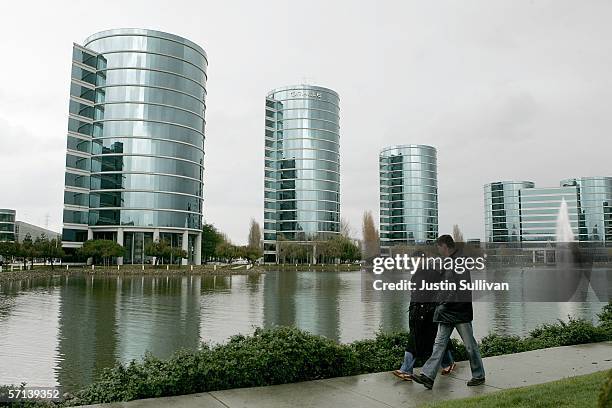 Pedestrians pass the Oracle Corp. Headquarters March 20, 2006 in Redwood City, California. Oracle Corp.?s quarterly profit increased 42 percent,...