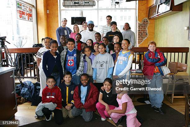 Reggie Evans and strength and conditioning coach Steve Hess of the Denver Nuggets join students from Columbine Elementary to make burritos at Illegal...