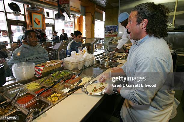 Strength and conditioning coach Steve Hess of the Denver Nuggets join students from Columbine Elementary to make burritos at Illegal Pete's...