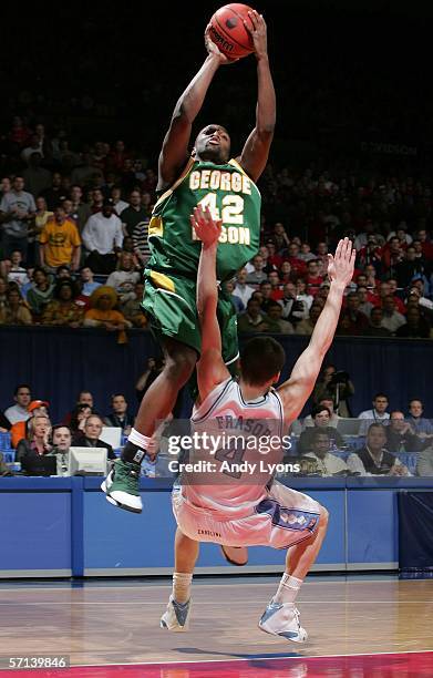 Folarin Campbell of the George Mason Patriots shots over Bobby Frasor of the North Carolina Tar Heels during the Second Round of the 2006 NCAA Men's...