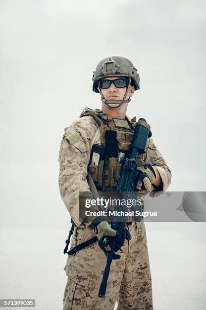 portrait of united states marine on patrol. - army helmet stockfoto's en -beelden