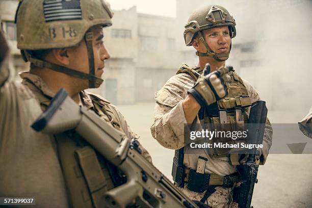 portrait of united states marines on patrol. - army helmet stockfoto's en -beelden