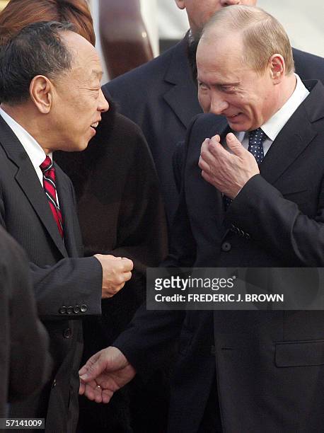 Visiting Russian President Vladimir Putin is greeted by Chinese Foreign Minister Li Zhaoxing on arrival at the airport in Beijing, 21 March 2006....