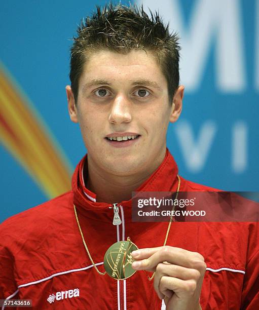 David Davies of Wales shows off his gold medal following his victory in the men's 1500m freestyle final at the Commonwealth Games in Melbourne, 21...