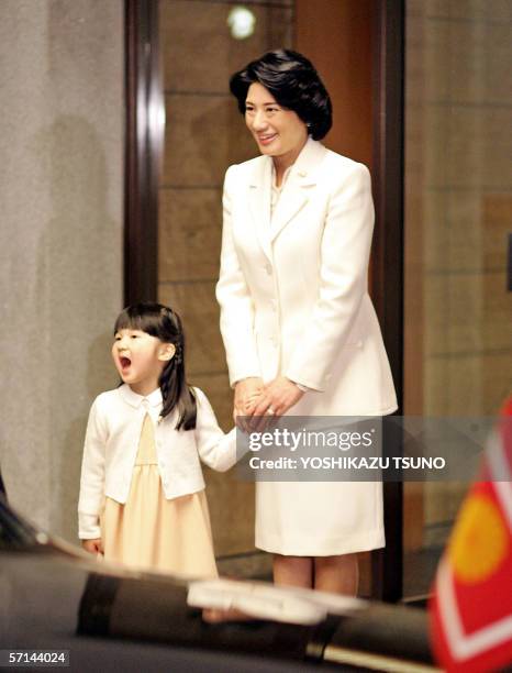 Japanese Princess Aiko , accompanied by her mother Crown Princess masako , reacts as her father Crown Prince Naruhito arrives at their residence Togu...