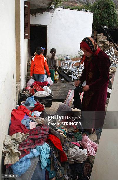 Woman and children assemble belongings 21 March 2006 in the town of Bejaia after an earthquake hit the nearby town of Laalam 20 March in northeast...