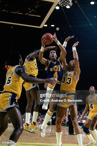 Adrian Dantley of the Utah Jazz drives to the basket against Kareem Abdul-Jabbar of the Los Angeles Lakers during an NBA game at the Forum circa 1985...