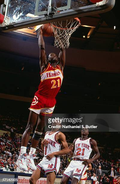 Dominique Wilkins of the Atlanta Hawks goes up for a slam dunk against the New York Knicks circa 1990 at Madison Square Garden in New York, New York....