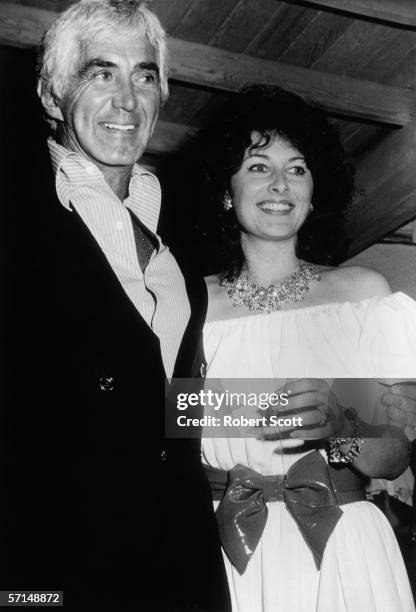 American car designer, engineer, and builder John DeLorean and his third wife supermodel, actress, and author Cristina Ferrare attend a party at...