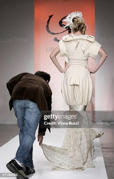 Designer Uriel Saenz and a model walk the runway at the Uriel Saenz Fall 2006 show during the Mercedes Benz Fashion Week at Smashbox Studios on March...