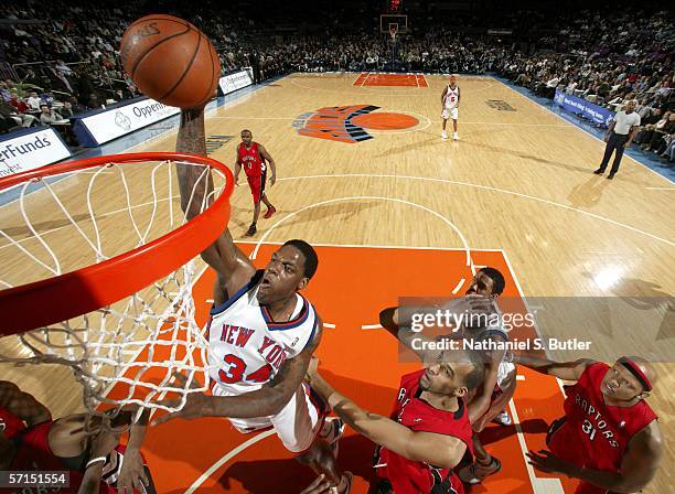 Eddy Curry of the New York Knicks dunks against Loren Woods of the Toronto Raptors at Madison Square Garden on March 21, 2006 in New York City. NOTE...