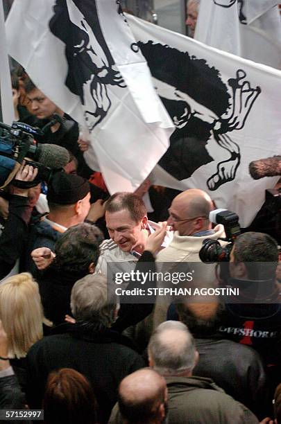 French Corsican militant Jean Castela is welcomed by well-wishers, 21 March 2006 upon his arrival at Bastia airport, Corsica, southern France, with...