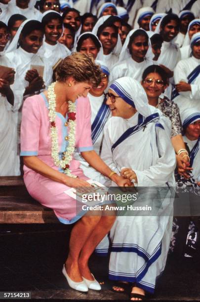 Princess Diana the Princess of Wales holds hands with a nun at Mother Teresa's Hospice in Calcutta during her visit to India in February of 1992.