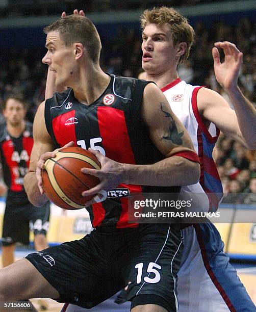 Lietuvos Rytas' Lithuanian center Javtokas Robertas protects the ball from Tau Ceramica's Spanish center Tiago Splitter during their EuroLeague...