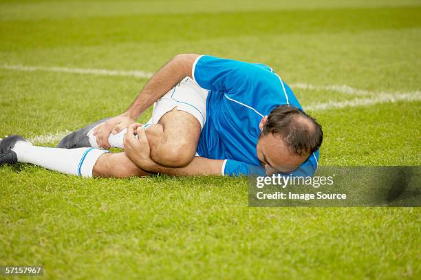 injured footballer - injured football player stock pictures, royalty-free photos & images