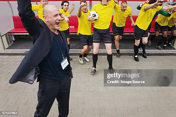 coach and football team cheering - coach cheering stock pictures, royalty-free photos & images