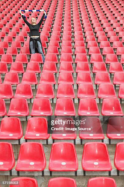female football fan alone in stadium - fans in the front row stock pictures, royalty-free photos & images