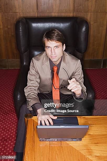 businessman using laptop - black leather computer chair stock pictures, royalty-free photos & images