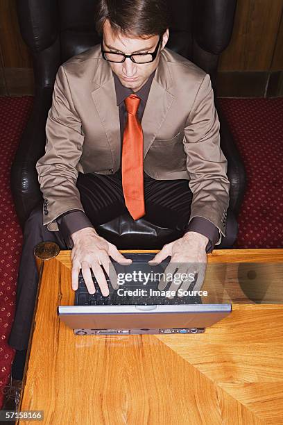 businessman using laptop - black leather computer chair stock pictures, royalty-free photos & images