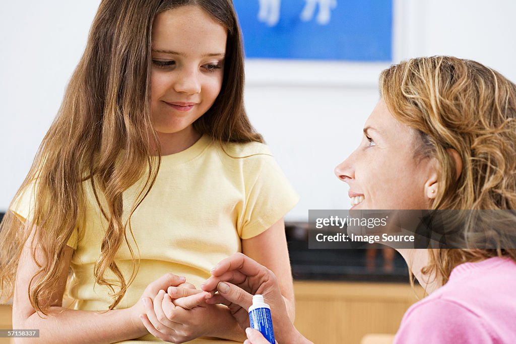 Mother applying antiseptic cream