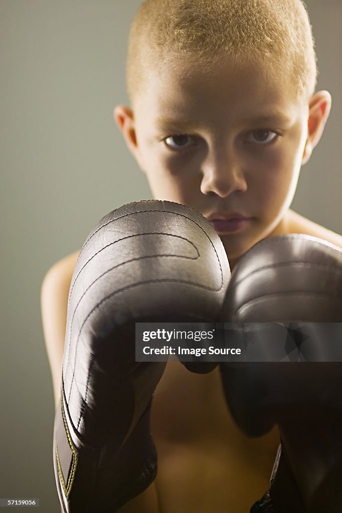 Boy wearing boxing gloves