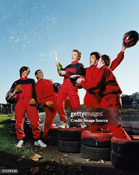 men celebrating at race track - spraying champagne stock pictures, royalty-free photos & images