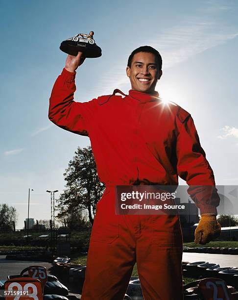 man celebrating at race track - red jumpsuit stock pictures, royalty-free photos & images