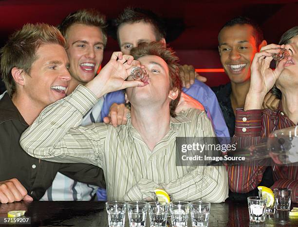 men drinking shots at a bar - alkoholism bildbanksfoton och bilder