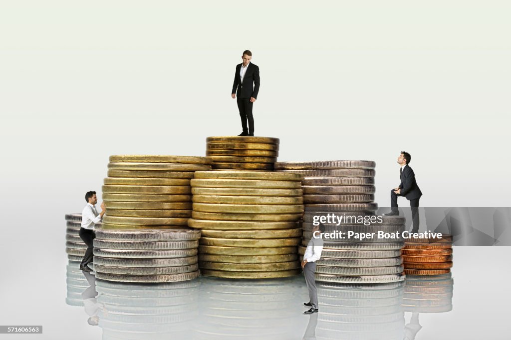 Group of businessmen standing on different coins