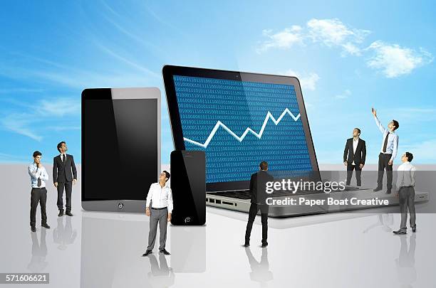 group of men looking at a laptop with stocks mark - hedge fund stock pictures, royalty-free photos & images