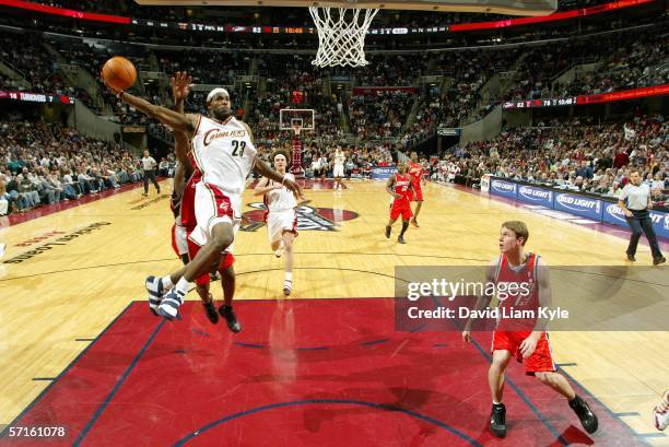 LeBron James of the Cleveland Cavaliers soars in for a dunk as Matt Carroll of the Charlotte Bobcats looks on, on March 22, 2006 at The Quicken Loans...