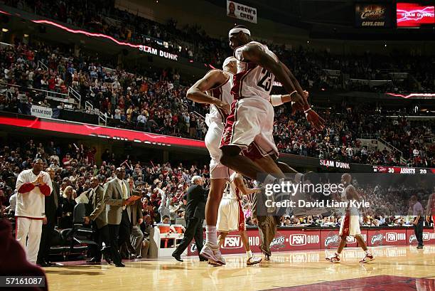 LeBron James of the Cleveland Cavaliers bumps teammate Drew Gooden after LeBron dunks off a steal during game against the Charlotte Bobcats on March...