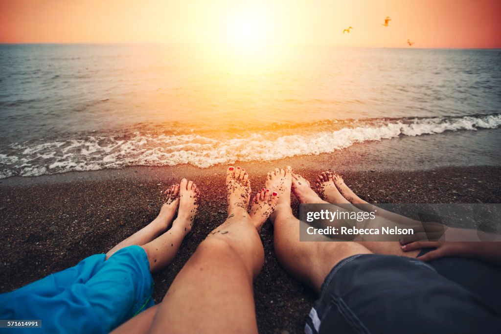 Family of four relaxing on beach