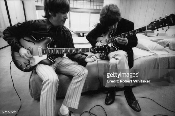 John Lennon and George Harrison backstage at the Nippon Budokan in Tokyo during the Beatles' Asian tour, 1966.