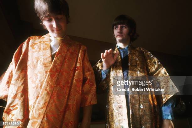 John Lennon and Ringo Starr try on a pair of gold embroidered kimonos in Tokyo during the Beatles' Asian tour, 1966.