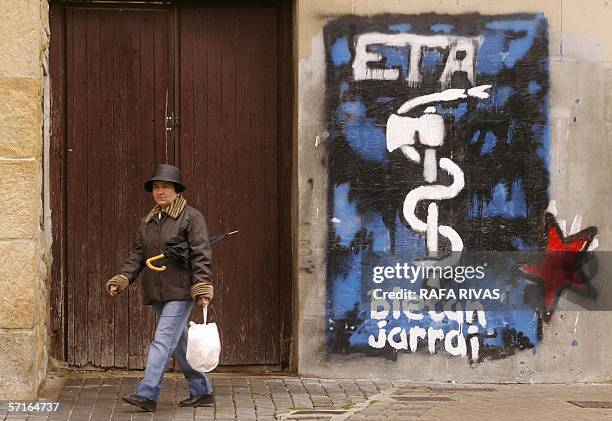 Woman walks past the logo of the pro-independence armed Basque group ETA, 23 March 2006 in the northern Spanish village of Alsasua, Navarra province....