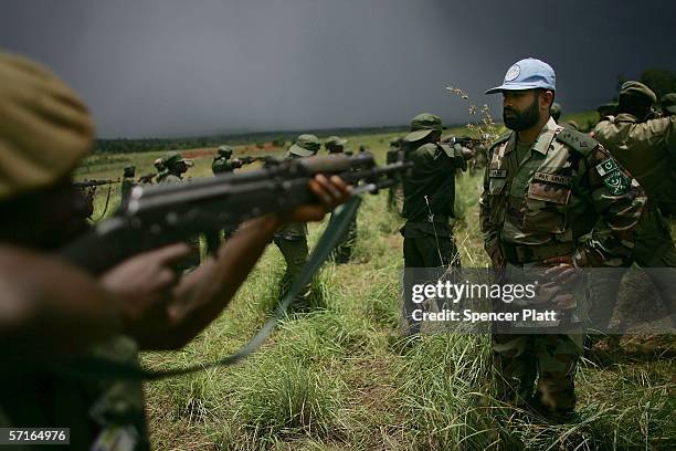Soldiers, the national army of the Democratic Republic of Congo, participate in training exercises with a United Nations peace keeper from Pakistan...
